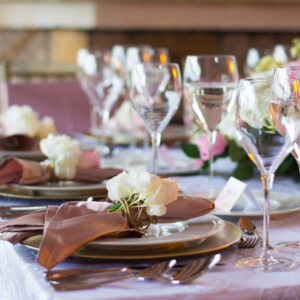 glasses of wine and plates in an elegant and formal banquet of a weddi